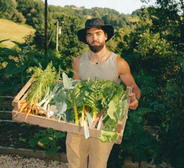 Gaz Oakley holding a box of veg